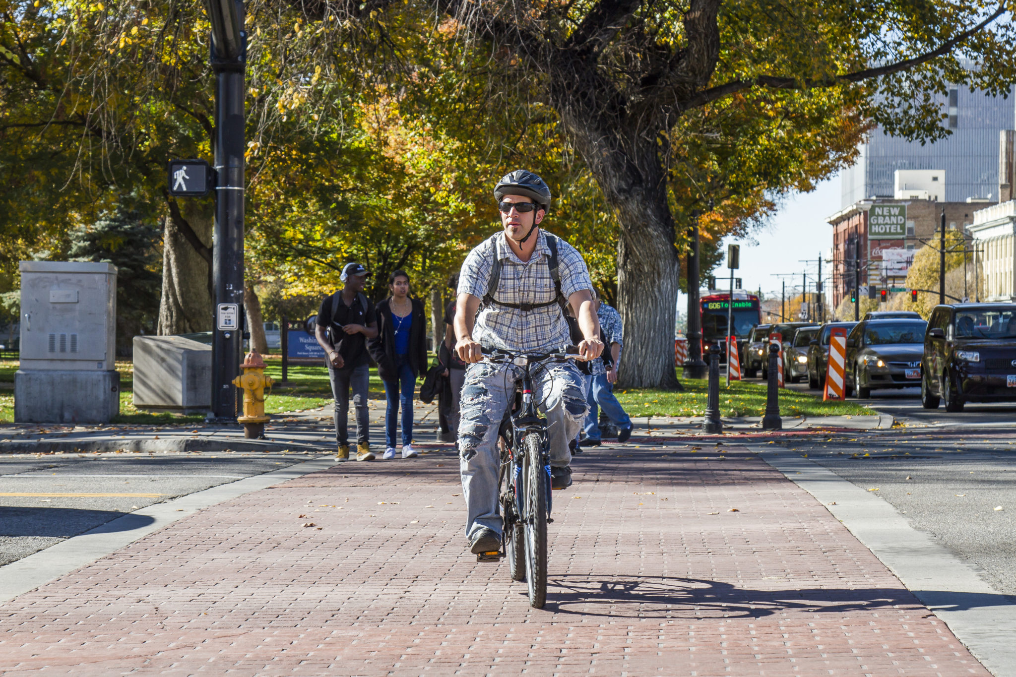 Bicyclist and pedestrians utilize crosswalk in Salt Lake City.