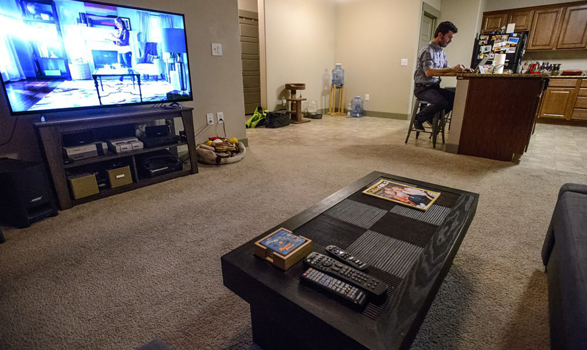 A Midvale Councilmember works on his computer in his apartment. Photo courtesy of Steve Griffin via The Salt Lake Tribune.