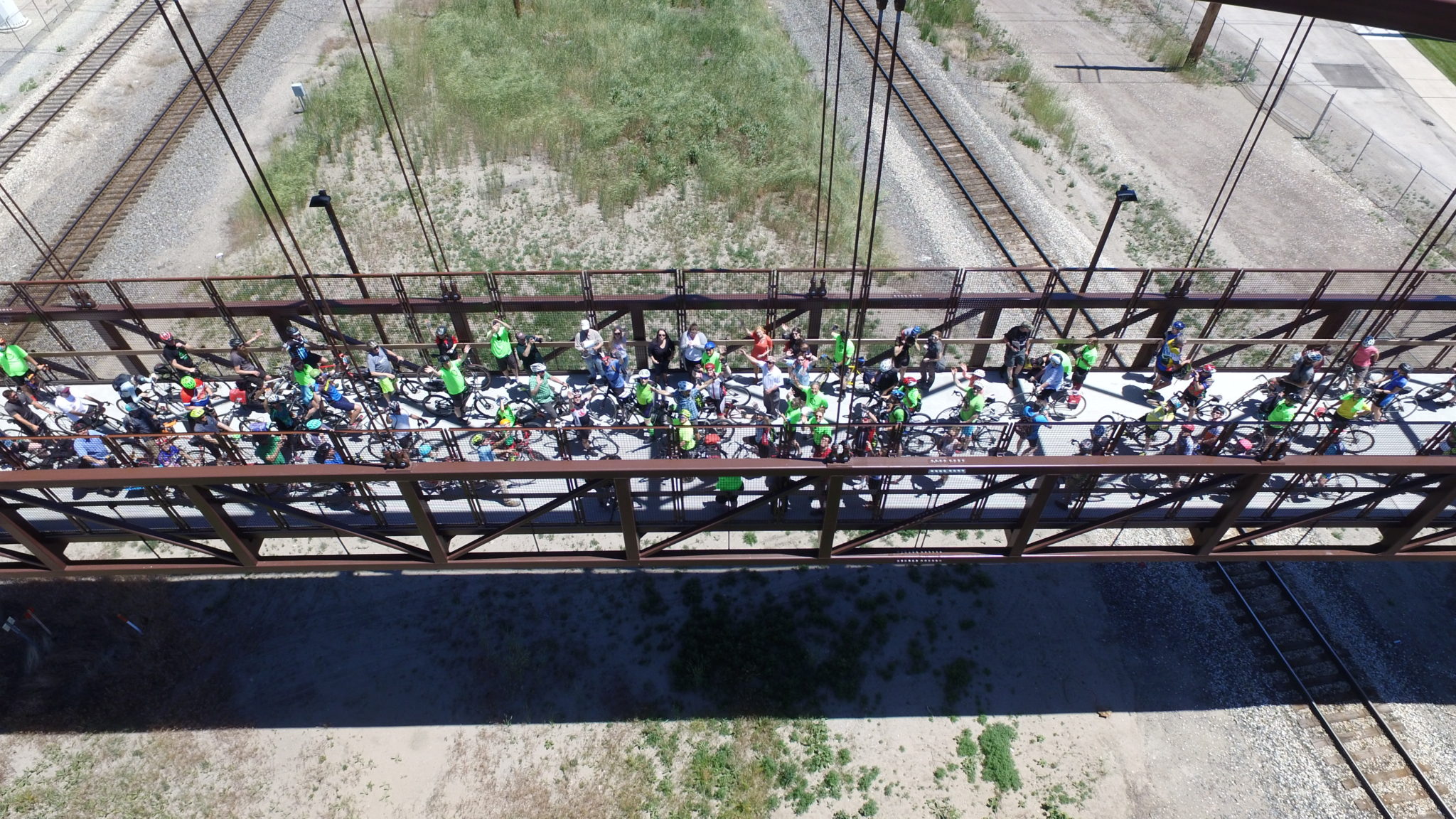 Drone image of bicyclists meeting on the Jordan River Bridge during the Golden Spoke Rides and Event. Image courtesy of Eric Mayer.